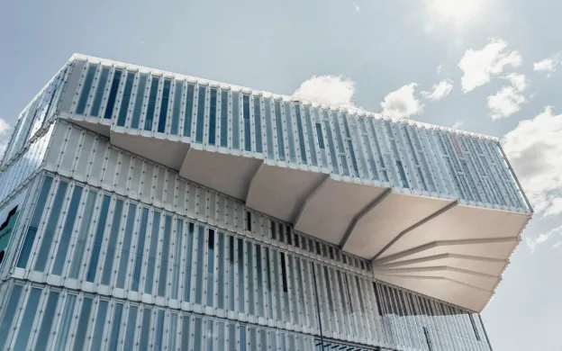 A modern building with a curved glass facade in Oslo.