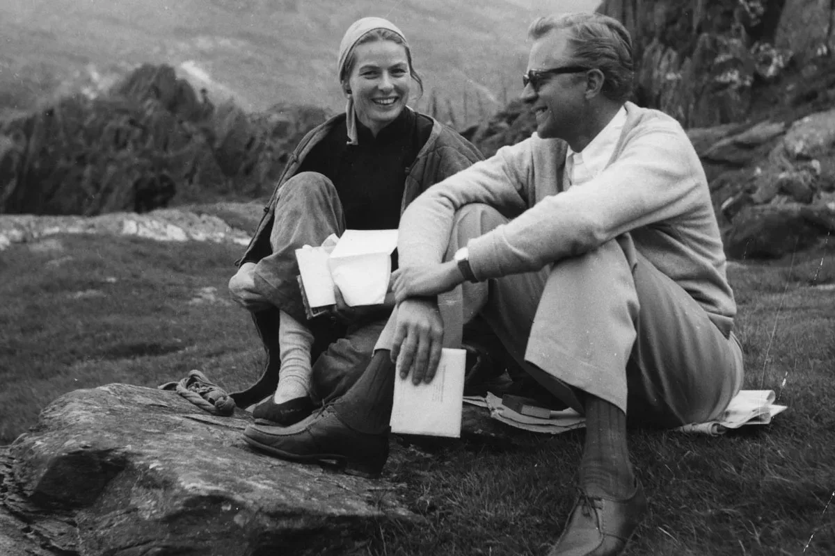 Ingrid Bergman and Lars Schmidt, Swedish theater producer and agent, and Ingrid's third husband, sitting on the ground outsite