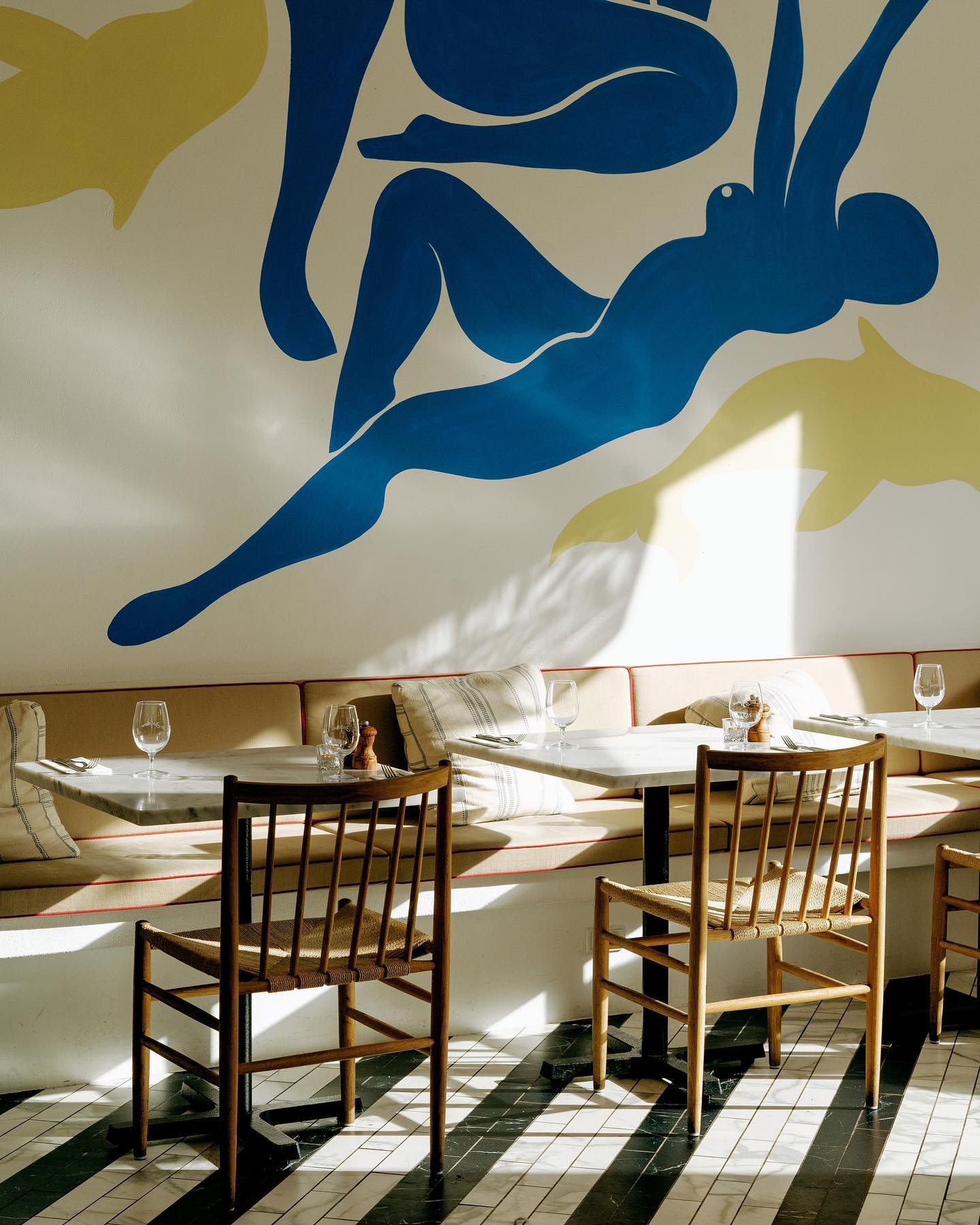 A Copenhagen restaurant with a mural on the wall.