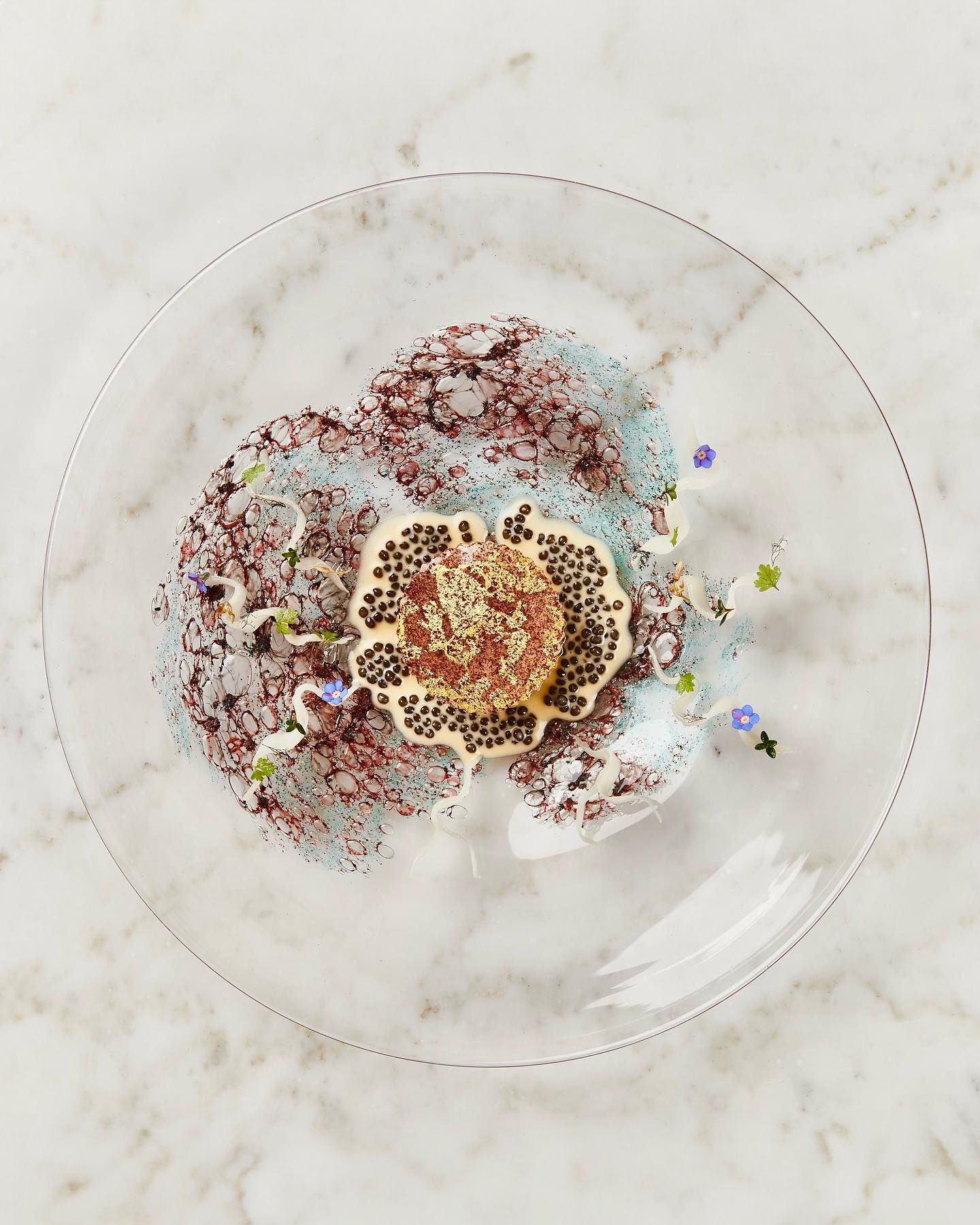 A dessert on a glass plate at a Copenhagen restaurant.