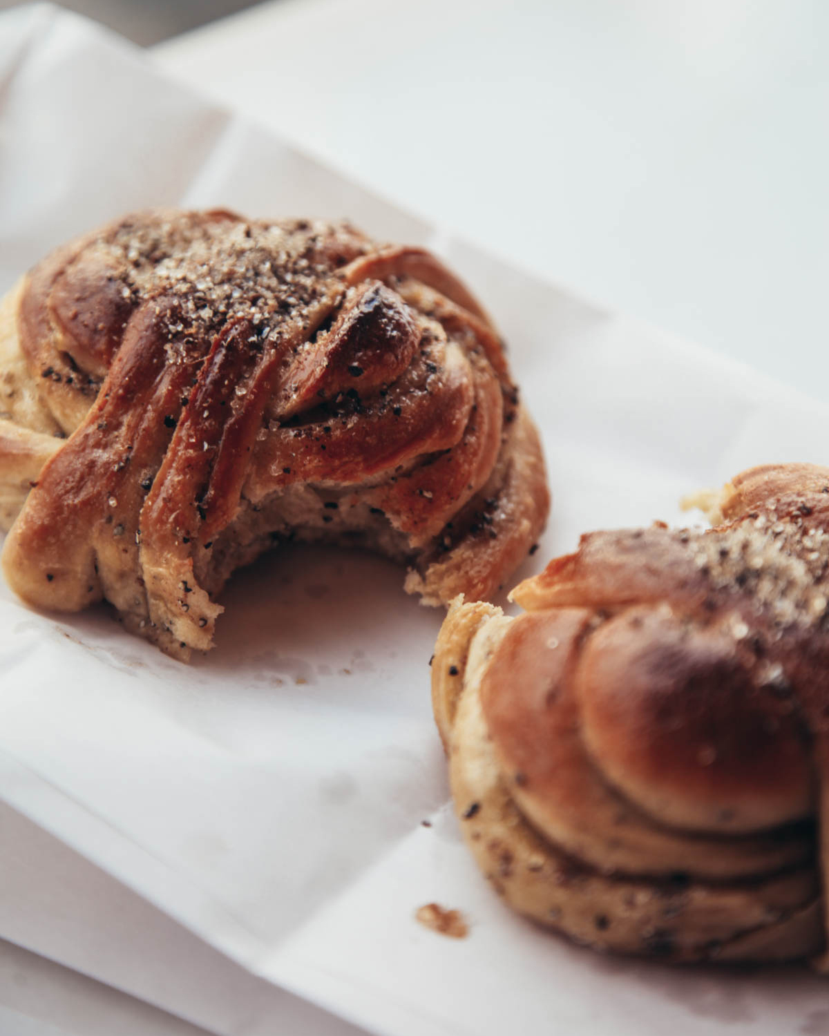 Two buns are sitting on top of a piece of paper in Copenhagen restaurants.