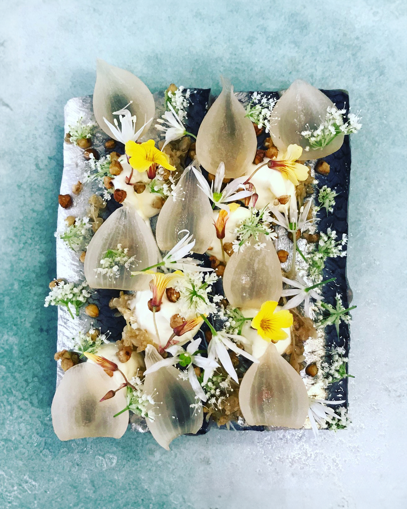 A plate topped with edible flowers at Copenhagen restaurants.