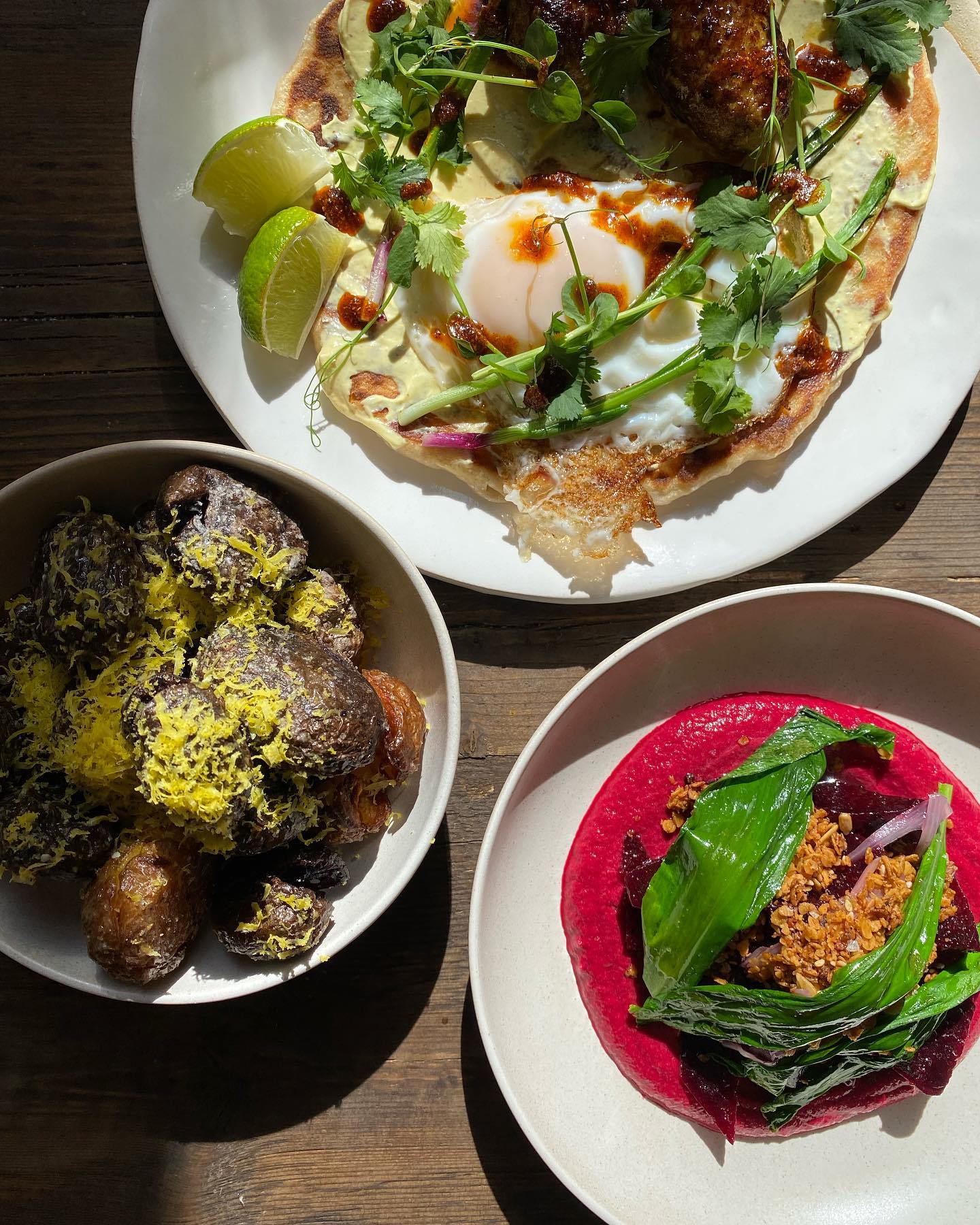 Three bowls of food on a table in Copenhagen restaurants.